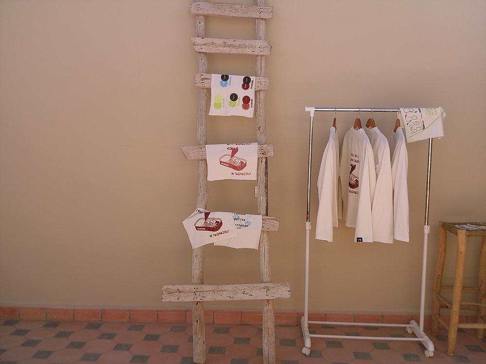 Échelle et portant avec les quatre tee-shirts sur une terrasse
