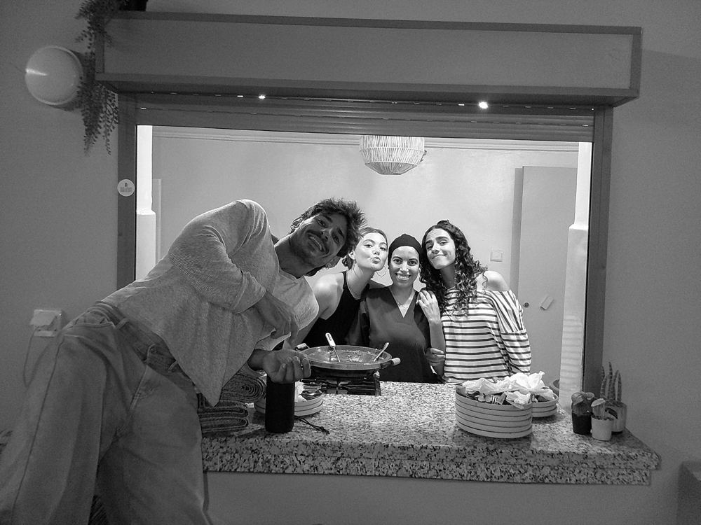 Maxence et trois amis derrière le passe-plat, en noir et blanc